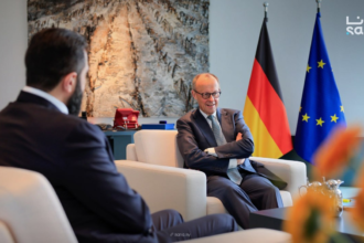 Syria at a Crossroads: Reconstruction, Returns, and Rising Controversy 4 Introduction: A Nation Re-emerging into Global Focus More than a decade after the outbreak of civil war in Syria, the country is once again at the center of international attention. Recent diplomatic developments, economic discussions, and security cooperation efforts suggest a shift in how global powers are engaging with Damascus. At the heart of this renewed focus is the controversial leadership of interim president Ahmed al-Sharaa and a growing willingness from European nations—particularly Germany—to re-engage with Syria politically and economically. This moment reflects a complex intersection of reconstruction ambitions, refugee policies, and geopolitical realities. A Diplomatic Reset: Germany and Syria Rebuild Ties One of the most significant recent developments is Germany’s effort to deepen cooperation with Syria, signaling a notable shift in European foreign policy. German Foreign Minister Johann Wadephul emphasized that Syria holds “enormous” potential as both a market and a production partner. He described the country as a “strategic hub between Europe, the Gulf states and the Indo-Pacific,” highlighting its geographic and economic relevance. This positioning suggests that Syria is no longer viewed solely through the lens of conflict but increasingly as a future economic partner. At a high-level economic forum in Berlin, German officials pledged support for: Rebuilding Syrian state institutions Supporting economic recovery Expanding bilateral trade opportunities Despite ongoing regional instability, Wadephul acknowledged that Syria has managed to prevent broader conflict spillover—calling it “a great success” given tensions across the Middle East. The Al-Sharaa Factor: Leadership, Legitimacy, and Criticism The visit of Ahmed al-Sharaa to Berlin marked a turning point—but also sparked controversy. 4 Al-Sharaa, a 43-year-old former militia leader, has a complex and contentious background. He previously commanded the al-Nusra Front, once linked to extremist networks. His rise to power following the overthrow of Bashar al-Assad in late 2024 has divided international opinion. While some governments see him as a necessary partner for stabilization, critics highlight: Allegations of human rights violations Concerns about minority protection Questions about democratic legitimacy His reception in Berlin reflected this divide. Supporters gathered enthusiastically, chanting “Allahu Akbar,” while protests and political criticism underscored deep unease about legitimizing his leadership. Even within Germany, political and civil society groups remain split. Some argue engagement is essential for peacebuilding, while others warn it risks compromising democratic values. Refugee Returns: Policy, Pressure, and Reality A central issue shaping Germany-Syria relations is the question of refugee repatriation. Germany currently hosts approximately 1 million Syrians, many of whom fled the civil war beginning in 2011. Chancellor Friedrich Merz has proposed an ambitious plan: 80% of Syrians in Germany should return within three years A joint task force will coordinate repatriation efforts Financial support—around €200 million—will assist Syria’s reconstruction However, the policy remains highly controversial. Key Challenges to Repatriation Security concerns: Conditions in Syria are still described as “volatile” Infrastructure damage: Many areas remain heavily destroyed Economic hardship: Limited access to jobs, food, and services Legal risks: Refugees who return may lose protected status abroad Non-governmental organizations have strongly cautioned against forced returns, arguing that safe and dignified conditions are not yet guaranteed. Reconstruction and Economic Opportunity Despite ongoing challenges, Syria is actively positioning itself for reconstruction and investment. Al-Sharaa has framed the country as entering a “new beginning,” emphasizing: Legal reforms to attract foreign investment Opportunities in energy, construction, and technology Efforts to stabilize governance structures Germany and other partners see potential in sectors such as: Infrastructure rebuilding Industrial production IT and software development Energy systems modernization This aligns with broader geopolitical dynamics, where Syria could serve as a logistical and economic bridge between regions. Security Developments: Intelligence and Regional Cooperation Recent events also highlight growing cooperation on security matters. In a notable operation, Turkish intelligence—working with Syrian authorities—captured a fugitive spy at the Syria-Lebanon border after more than a decade on the run. The case underscores: Increasing coordination between regional intelligence agencies Syria’s evolving role in cross-border security Ongoing concerns about espionage and militant networks Such developments suggest that beyond reconstruction, Syria remains a critical player in regional stability and intelligence dynamics. A Fragile Stability in a Volatile Region Despite signs of progress, Syria’s situation remains deeply complex. German officials acknowledge that while conditions have “fundamentally improved,” the broader environment is still unstable. Key risks include: Spillover from regional conflicts (including tensions involving Iran) Internal political fragmentation Ongoing humanitarian challenges Ethnic and sectarian tensions At the same time, Syria has managed—so far—to avoid being drawn into escalating regional conflicts, which some leaders view as a sign of cautious stabilization. What Comes Next: A Critical Turning Point Syria now stands at a pivotal moment. Three parallel trajectories are shaping its future: Reconstruction and economic reintegration Refugee return and demographic shifts Political legitimacy and governance reform The success—or failure—of these efforts will determine whether Syria can transition from a post-conflict state into a stable and functioning nation. Conclusion: Between Opportunity and Uncertainty The re-engagement between Syria and international partners marks a significant shift in global attitudes. Economic cooperation, refugee policy, and security collaboration all point toward a country attempting to rebuild and redefine its role. Yet, the path forward remains uncertain. The leadership of Ahmed al-Sharaa continues to divide opinion, while the realities on the ground challenge optimistic timelines for recovery and repatriation. Syria’s future will depend not only on international support but also on its ability to address internal divisions, rebuild trust, and create conditions for a genuinely inclusive and stable society.