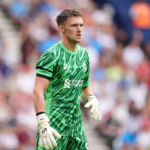 Liverpool beat Everton 2-1 but face goalkeeper concerns. Woodman debut explained with Alisson and Mamardashvili updates.