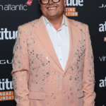 Alan Carr biography covering net worth, age, career, family, relationships, TV shows, BAFTA wins, marriage, comedy tours, and latest updates.