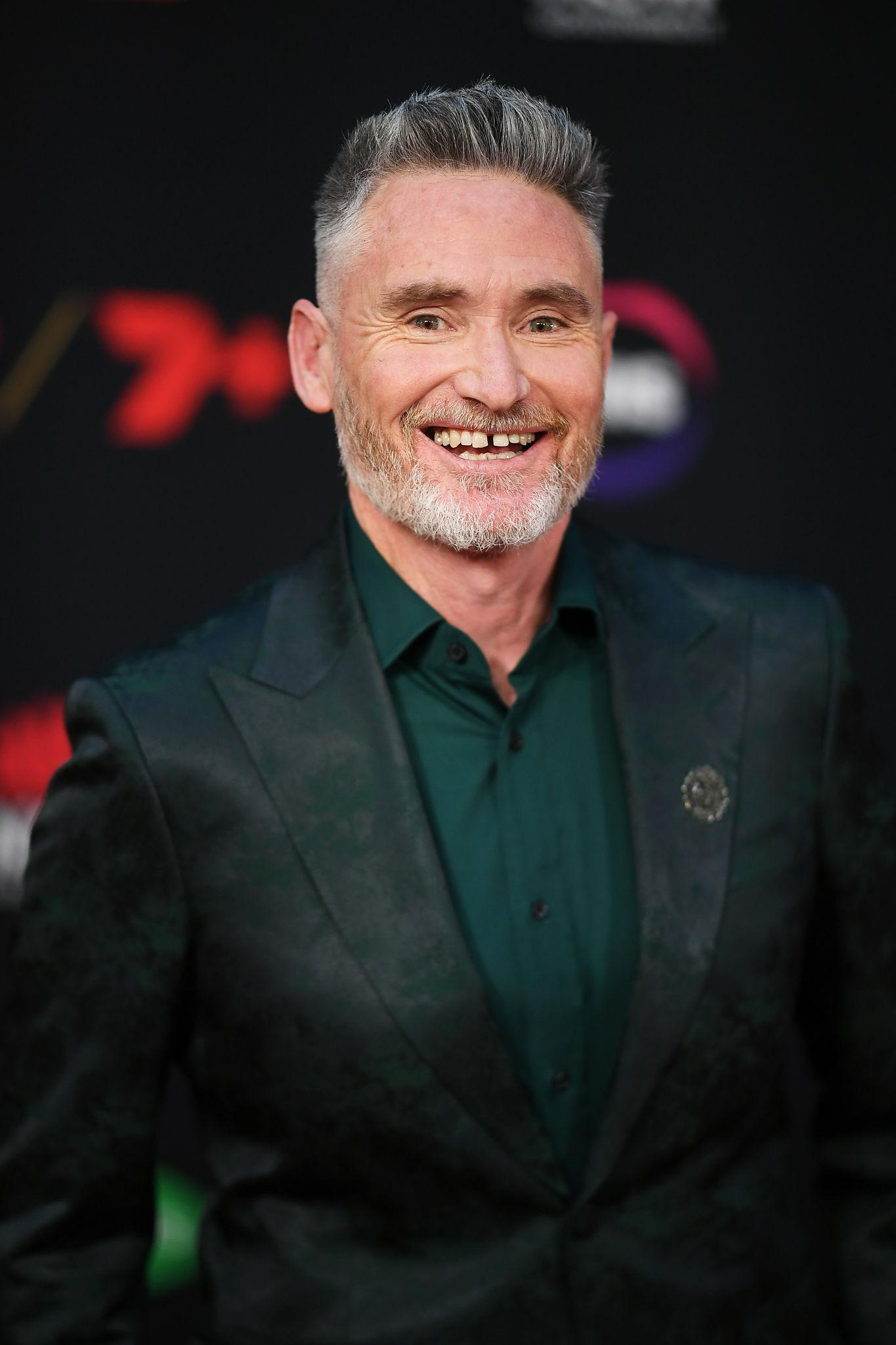 Dave Hughes returns to football after broken ribs and a punctured lung while opening up about sobriety and comedy addiction.